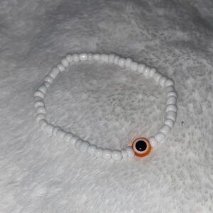 Handmade White Beaded Bracelet with Orange Accent
